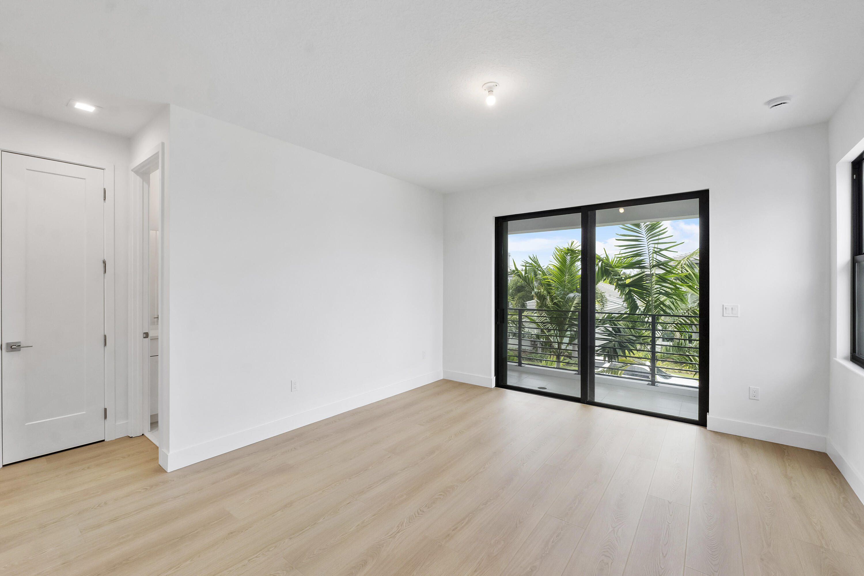 9322 Sunflower Mdw Road Boca Raton, FL 33434 - Photo 55 of 87 an empty room with wooden floor and windows