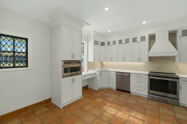 a kitchen with a sink cabinets and appliances