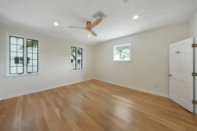 a bathroom with a granite countertop toilet a sink a mirror and shower