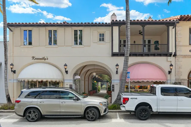 a view of a street with a cars park side of a road