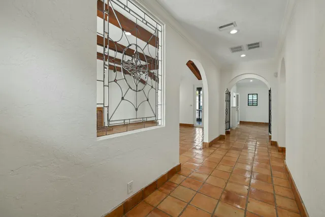 a view of a hallway with wooden floor and a living room