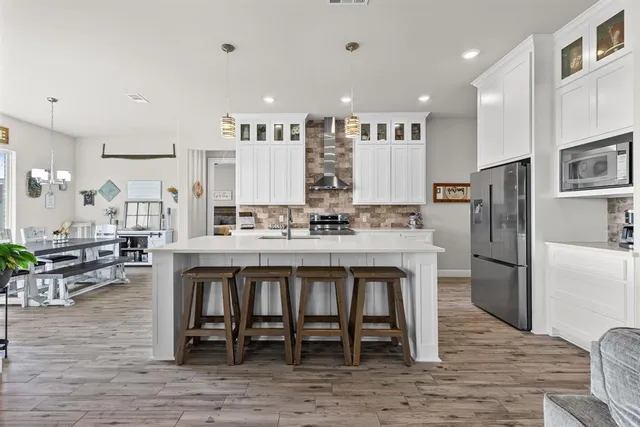 a large kitchen with a table and chairs