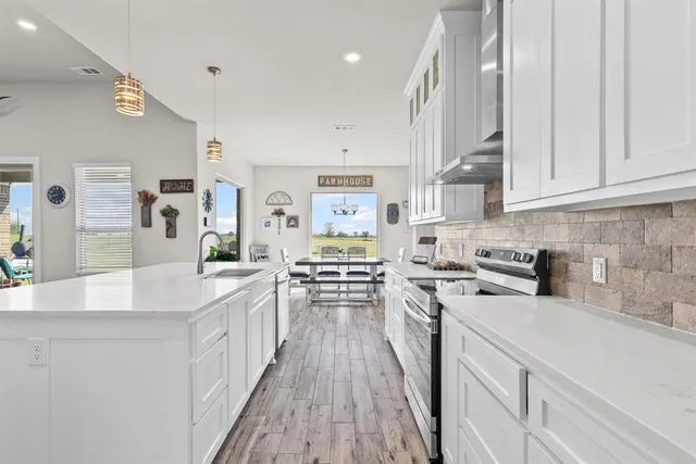 a kitchen with stainless steel appliances granite countertop a stove and a sink