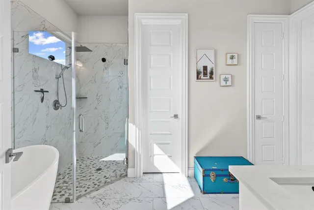 a bathroom with a tub sink and mirror