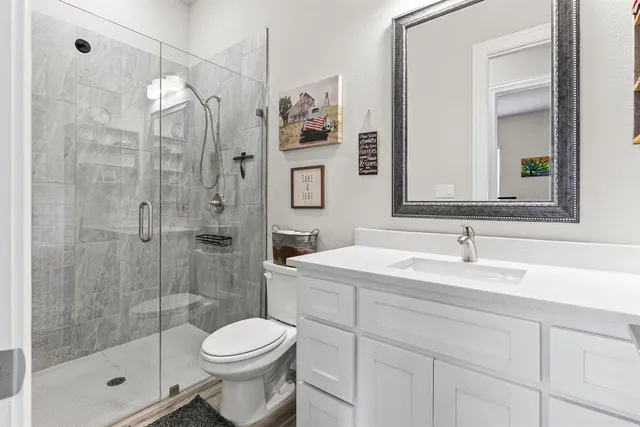 a bathroom with a sink toilet and shower