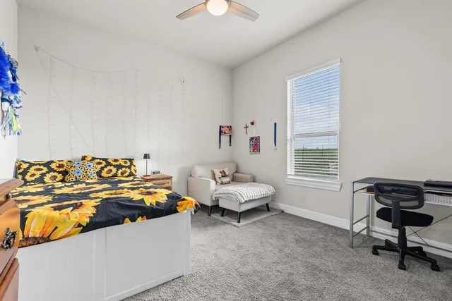 a bedroom with furniture and a window