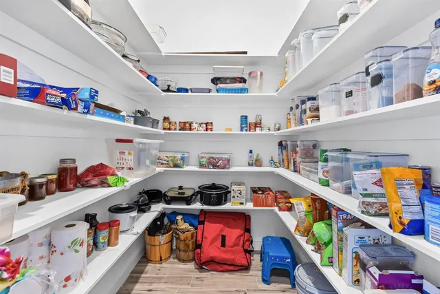 a utility room with lots of clutter and cabinets