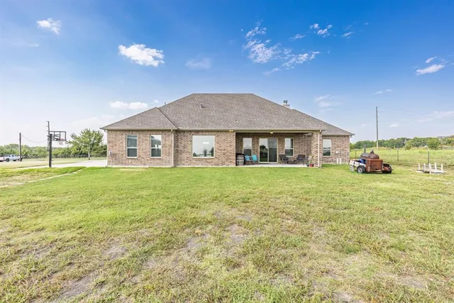a front view of house with yard and patio
