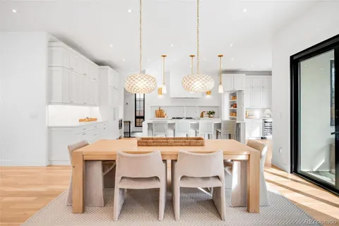 a kitchen with kitchen island a dining table and chairs