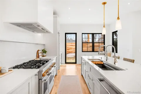 a kitchen that has a sink and a stove