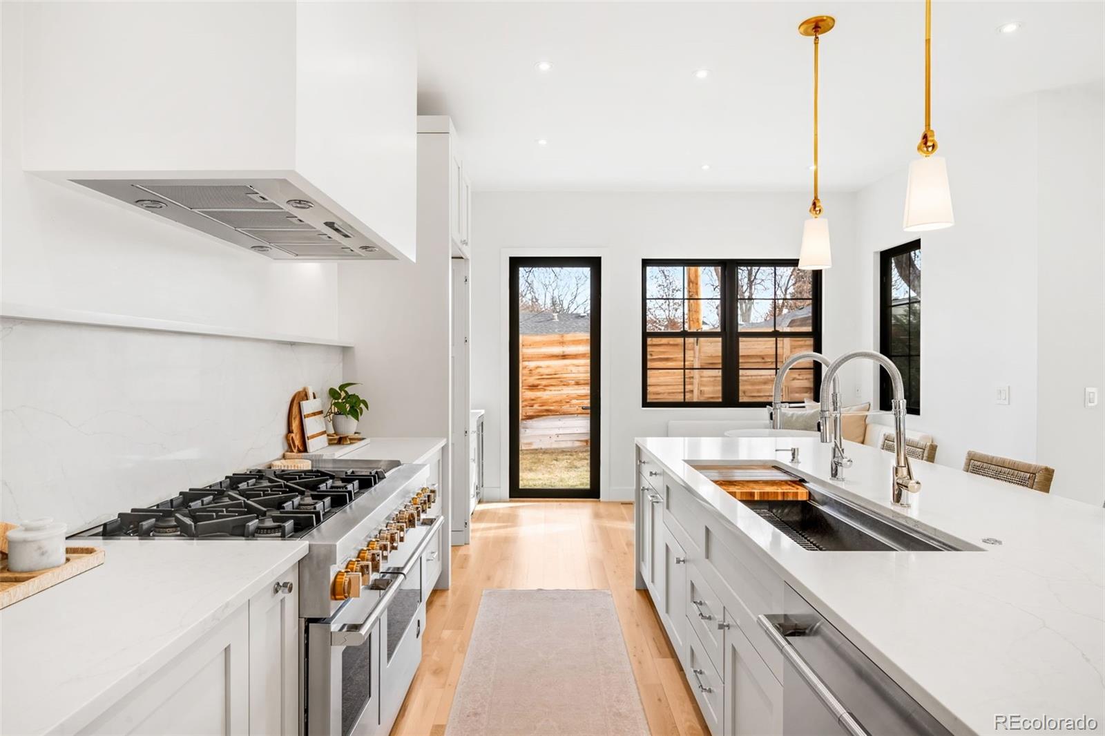2900 South Madison Street Denver, CO 80210 - Photo 15 of 46 a kitchen that has a sink and a stove