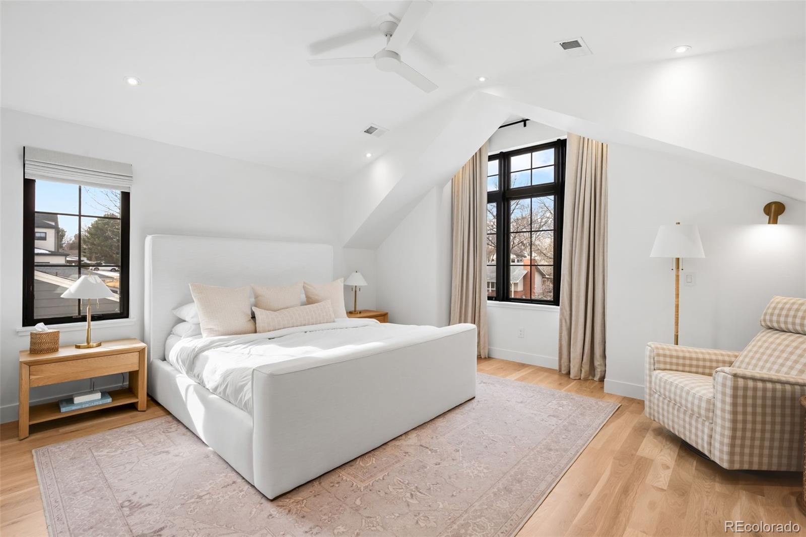 2900 South Madison Street Denver, CO 80210 - Photo 19 of 46 a spacious bedroom with a bed and a couch