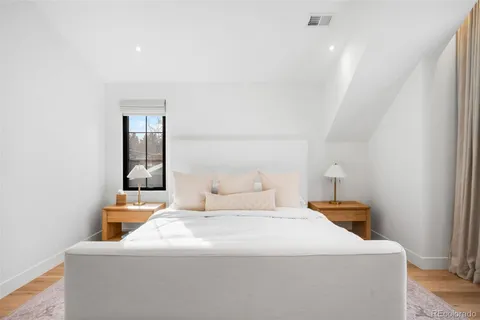 a bedroom with a bed and a night stand