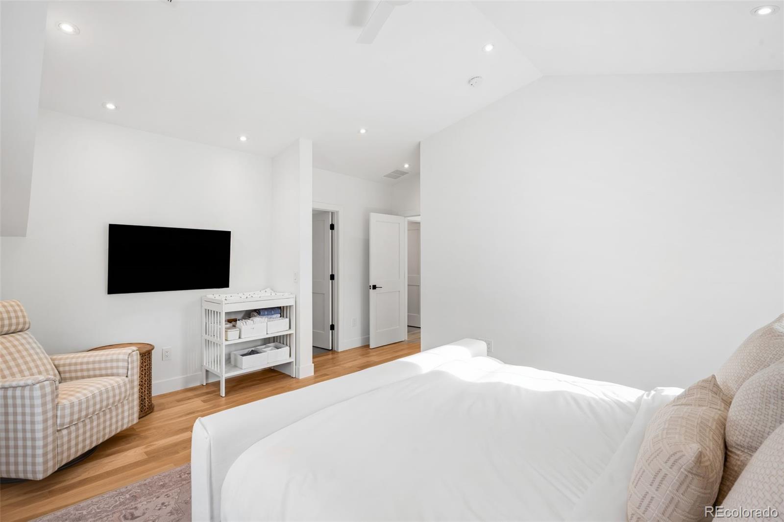 2900 South Madison Street Denver, CO 80210 - Photo 21 of 46 a bedroom with a bed and a flat screen tv