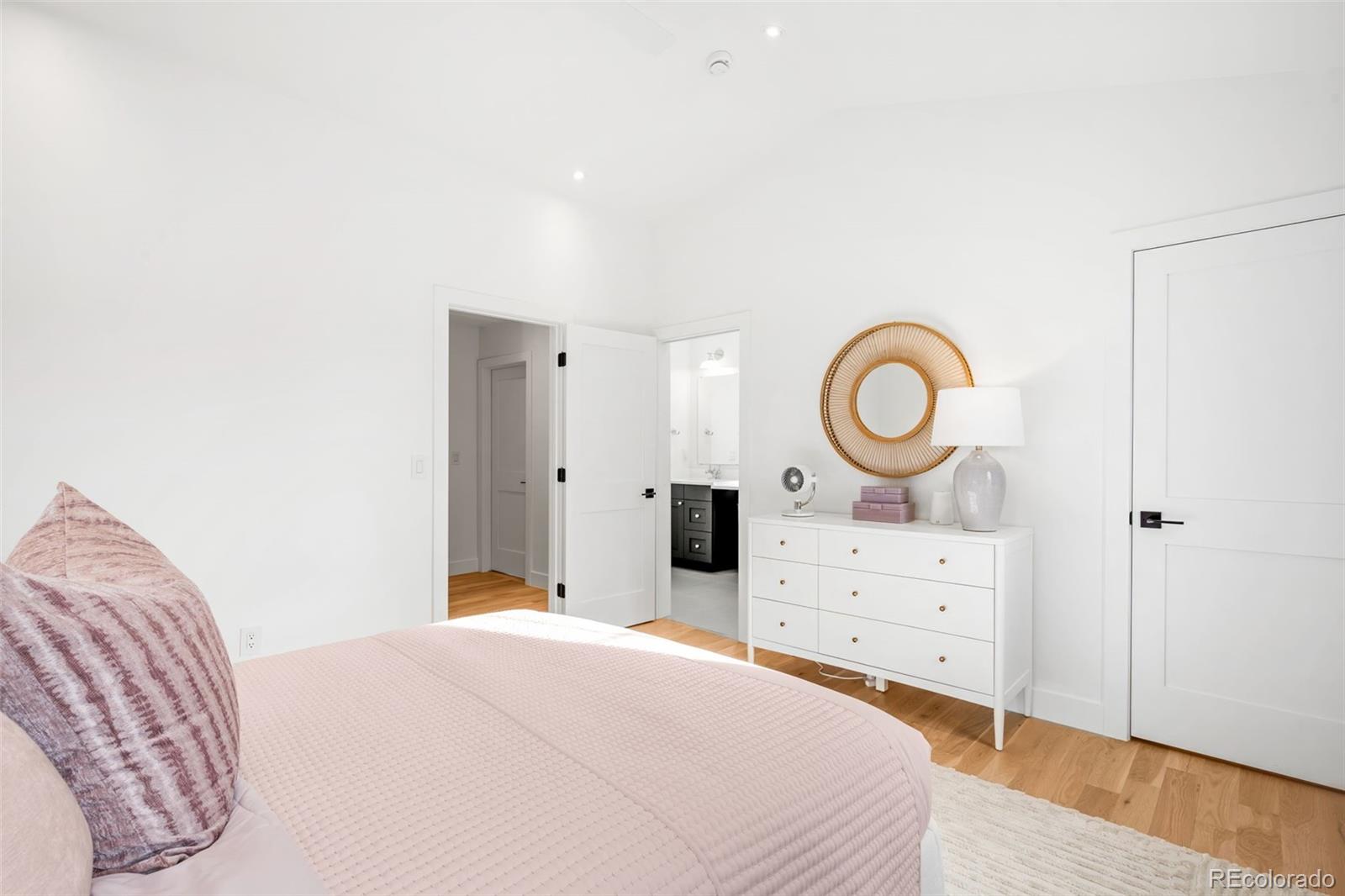 2900 South Madison Street Denver, CO 80210 - Photo 30 of 46 a bedroom with a bed and a dresser in it