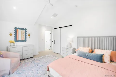 a bedroom with a bed and a couch