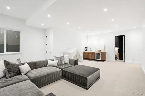 a living room with furniture and kitchen view