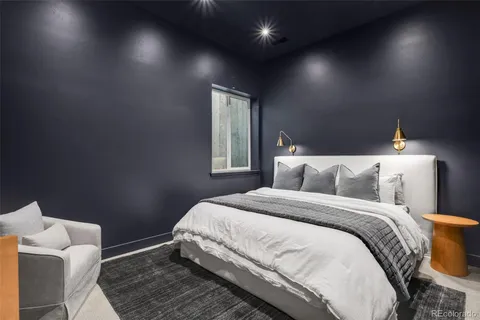 a bed sitting in a bedroom next to a window