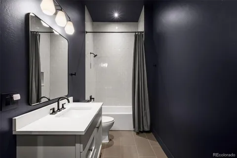 a bathroom with a sink a mirror and a shower