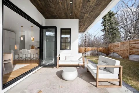 a view of a patio with couches chairs and a fire pit