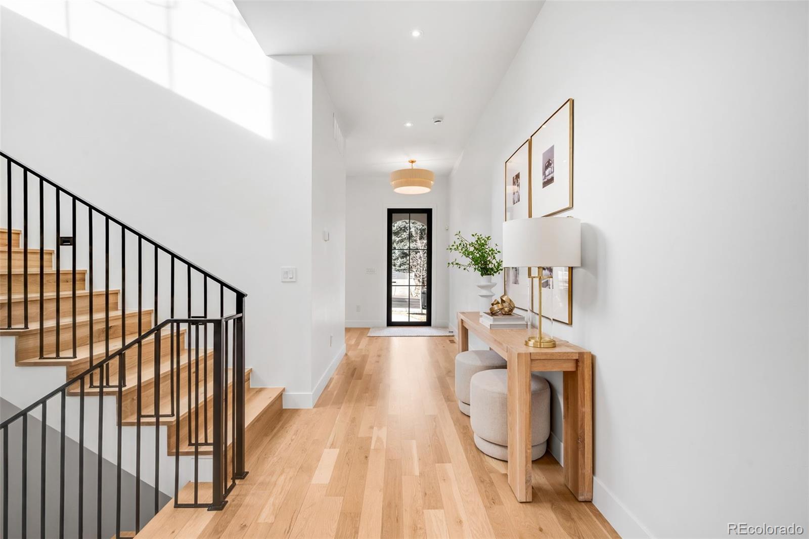 2900 South Madison Street Denver, CO 80210 - Photo 5 of 46 a view of a hallway with furniture and staircase