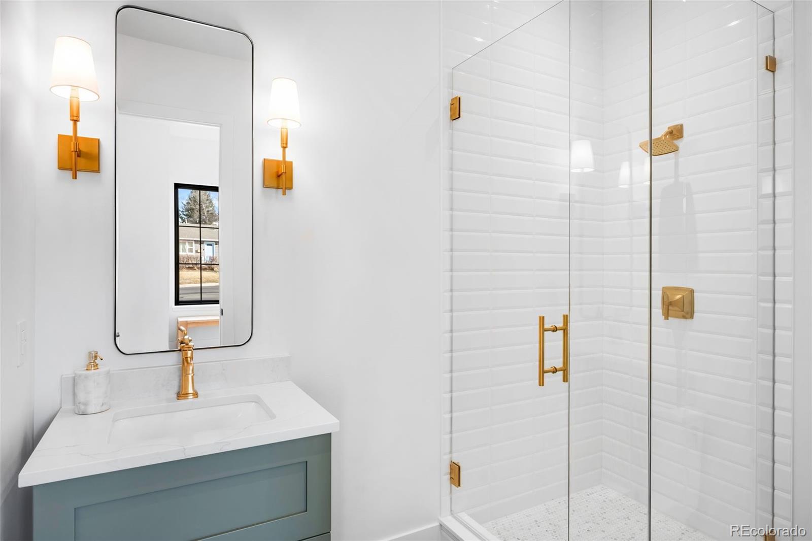 2900 South Madison Street Denver, CO 80210 - Photo 7 of 46 a bathroom with a sink and mirror