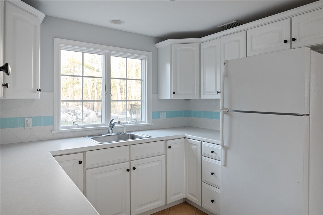 38 Miss Fry Drive East Greenwich, RI 02818 - Photo 30 of 47 Finished lower level kitchen walks out to pool and backyard