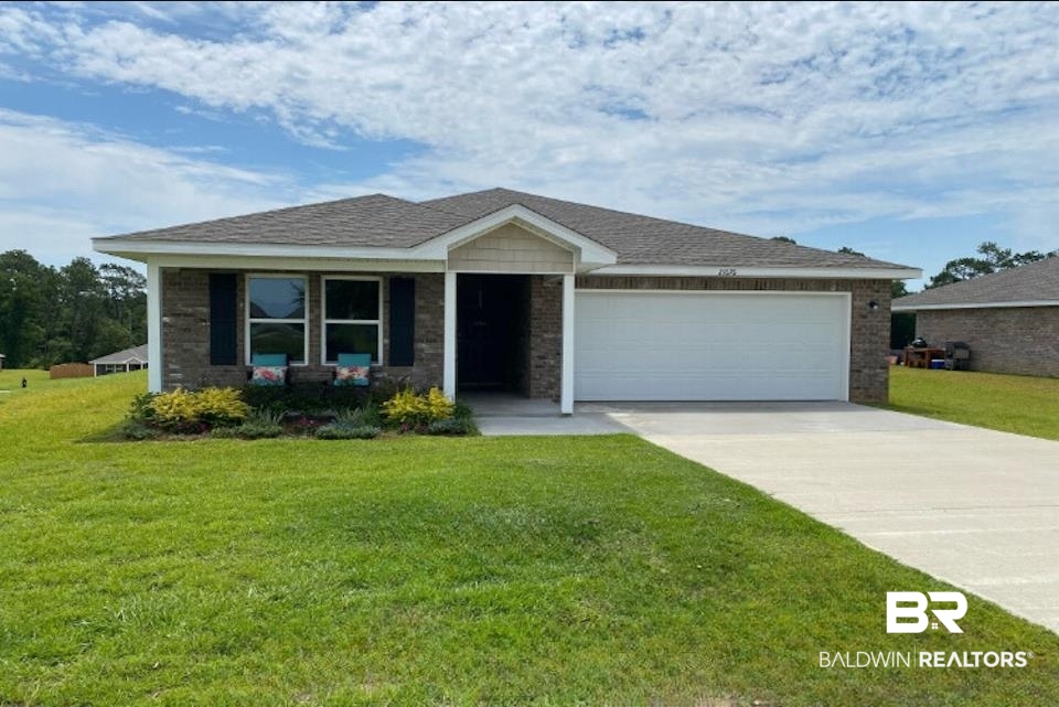 21676 Yosemite Boulevard Fairhope, AL 36532 - Photo 1 of 19 Ranch-style home featuring a front lawn and a garage