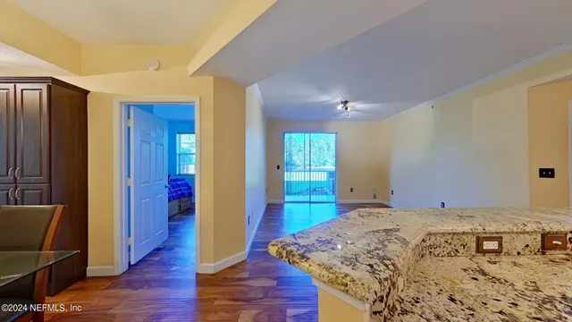 a view of a bedroom with wooden floor and windows