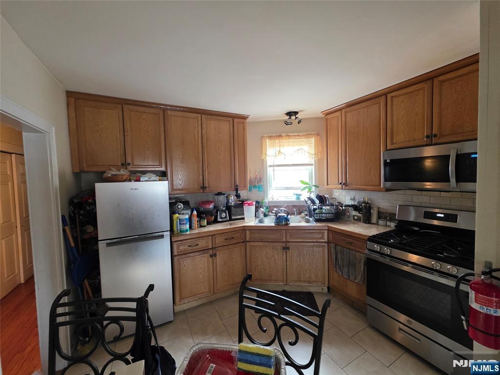 1449 Teaneck Road Teaneck, NJ 07666 - Photo 18 of 26 a kitchen with a refrigerator stove and microwave