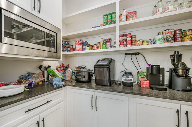 a kitchen with lots of clutter and cabinets