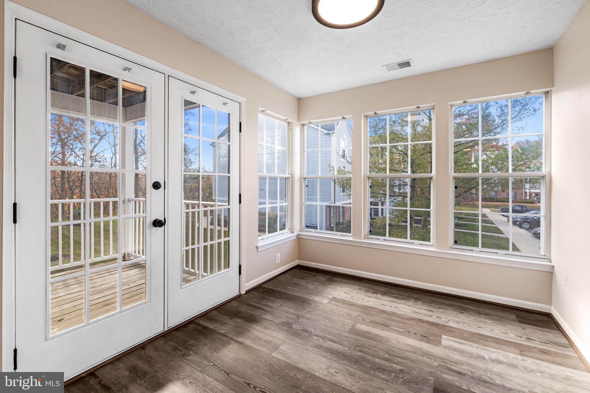 41 Laurel Path Court, Unit 5 Baltimore, MD 21236 - Photo 15 of 32 an empty room with wooden floor and windows