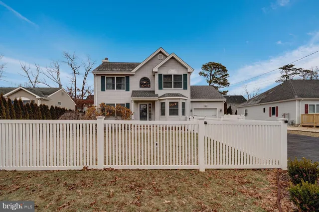 a front view of a house with a fence