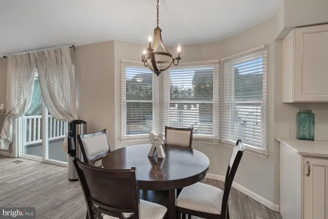 a kitchen with stainless steel appliances granite countertop a stove a sink and white cabinets