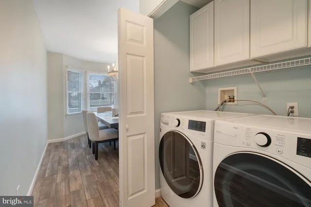 a dining room with furniture a chandelier and wooden floor