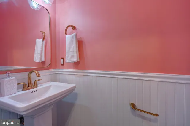 a bathroom with a granite countertop sink and a toilet