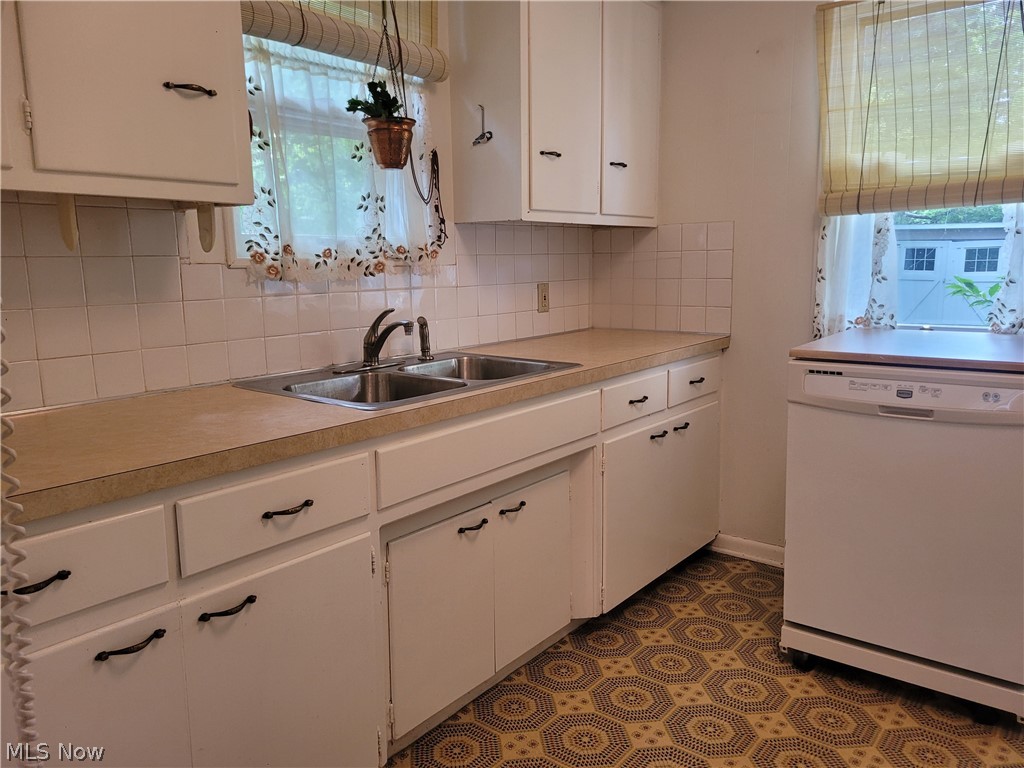 3953 Ardmore Road Cleveland Heights, OH 44121 - Photo 11 of 28 Kitchen featuring white cabinetry, backsplash, sink, easy to keep flooring, and dishwasher