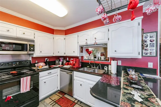 a kitchen with a sink stove and cabinets