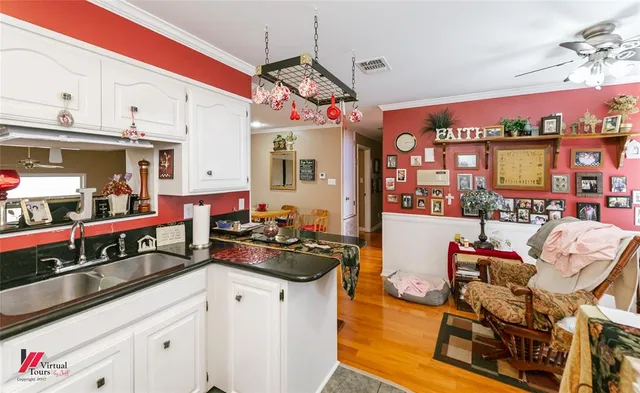 a view of a dining room with furniture and chandelier