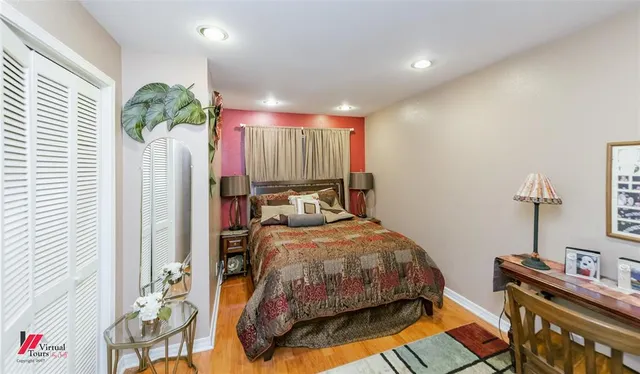 a bedroom with a bed and large window