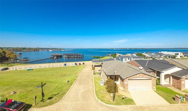 a bedroom with a bed flat screen tv and dresser