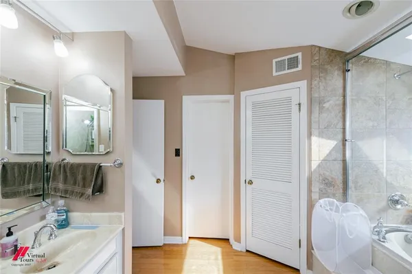 a bathroom with a bathtub and a shower