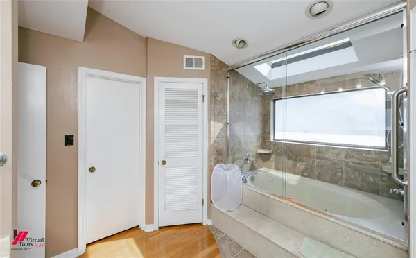 a bed room with furniture and a flat screen tv