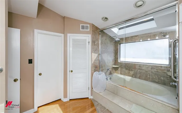 a bed room with furniture and a flat screen tv