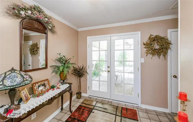 a living room with patio furniture and a potted plant