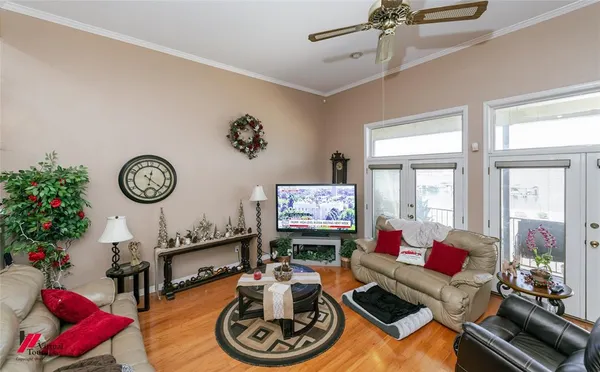 a living room with furniture a flat screen tv and a large window