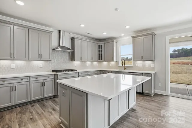 a kitchen with stainless steel appliances granite countertop a sink and cabinets
