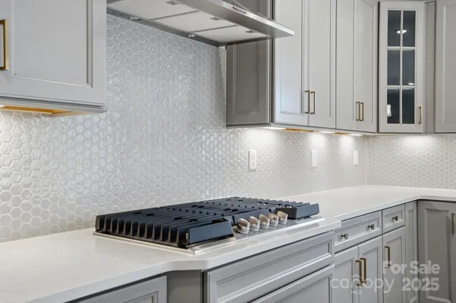 a kitchen with cabinets and a stove top oven