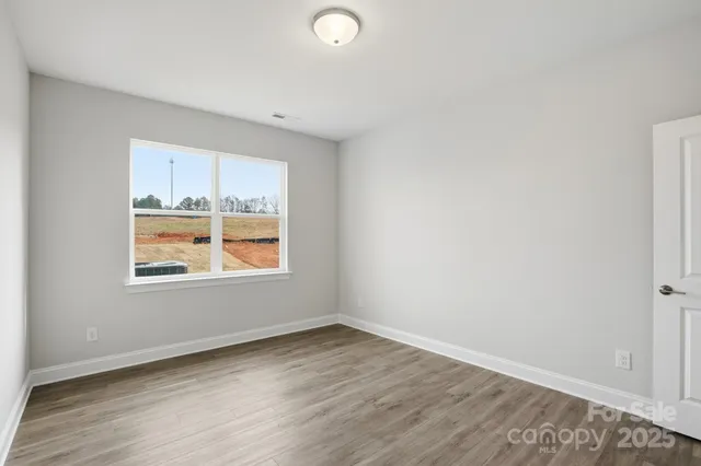 a view of an empty room and wooden floor