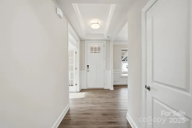 a view of a hallway with wooden floor